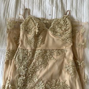 Lace beige with gold details dress. Size is a small I believe (2-4)